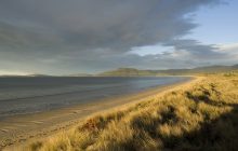 early evening with dark storm clouds over 7 mile beach, hobart, tasmania